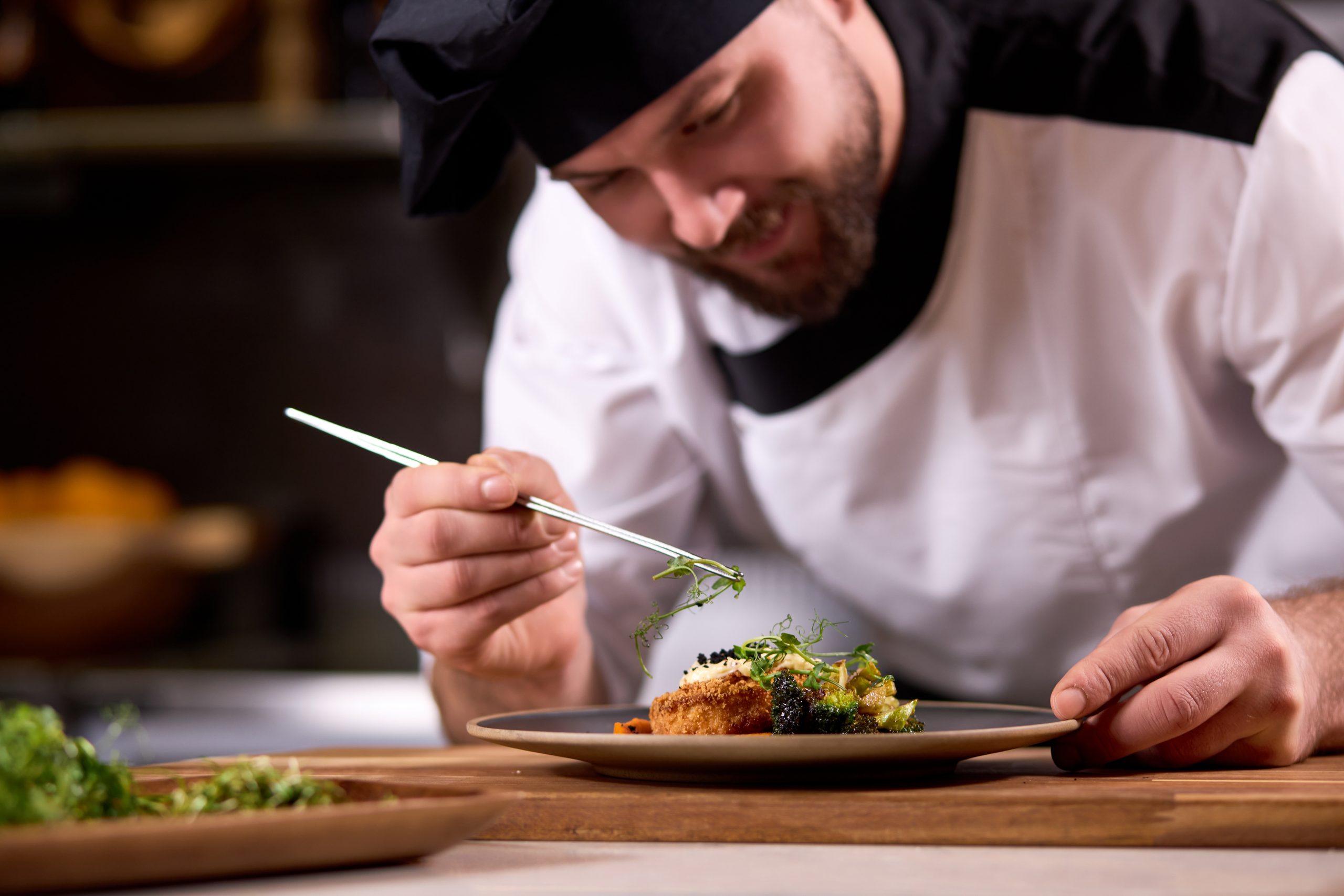 Chef de Cozinha arrumando salada com verduras frescas