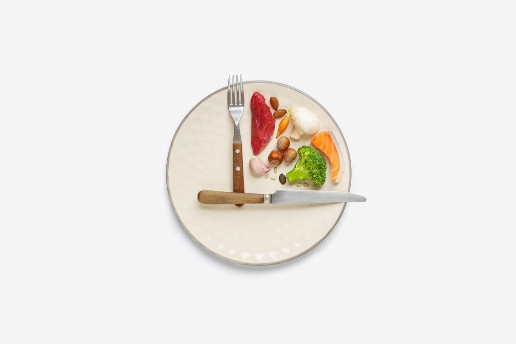 Foto conceito de prato com garfo e faca imitando um relógio